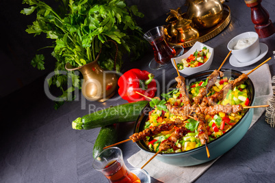 Lamb skewers with curry rice and different vegetables