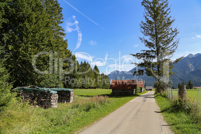 Mountain huts on green meadows in the Alps