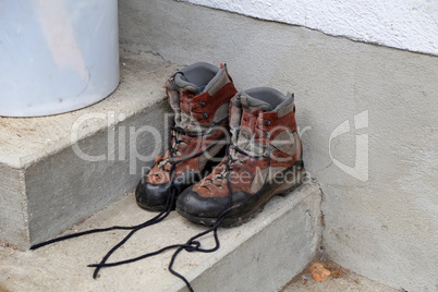 Dirty shoes stand on the porch of the house