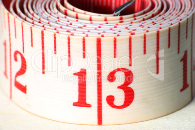 A white rolled measuring tape showing centimeters