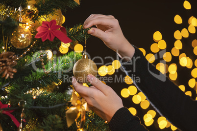 Girl decorates a Christmas tree