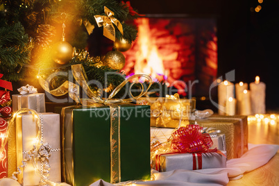 Christmas presents and candles under Christmas tree