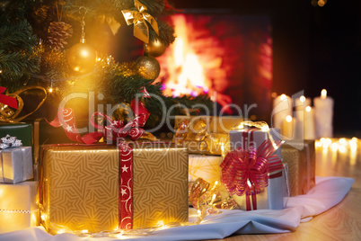 Christmas presents and candles under Christmas tree