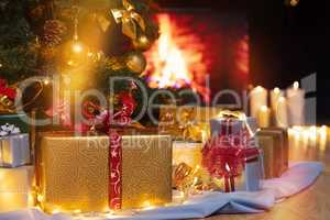 Christmas presents and candles under Christmas tree