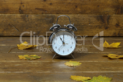 Autumn still life with an old alarm clock