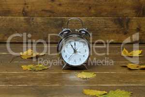 Autumn still life with an old alarm clock