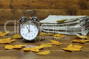 Autumn still life with an old alarm clock