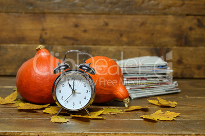 Autumn still life with an old alarm clock