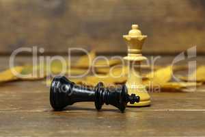 Chess pieces - White queen and defeated black king