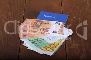 Euro money in a savings book on a table