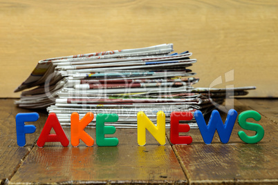 Fake news concept with newspapers and letters