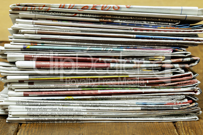 A stack of folded newspapers on the desktop