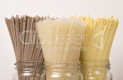 Different sorts of dry pasta in glass jars.