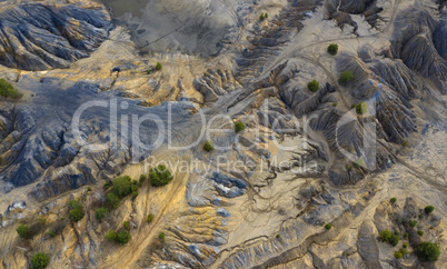 Aerial view of dunes of sand and clay in an abandoned quarry.