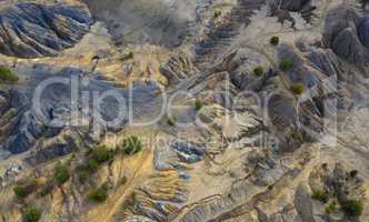 Aerial view of dunes of sand and clay in an abandoned quarry.