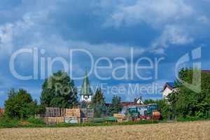 rural scene with church tower and farm