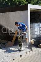 Construction worker compacting soil using compactor. Work with tamping machine