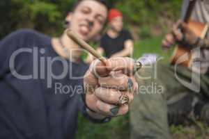 Boy holds out a joint 3