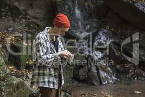 Boy prepares a joint in the woods 2