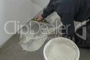 The worker installing new vinyl tile floor