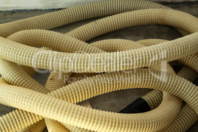 Yellow plastic corrugated tubes for water supply, rolled up