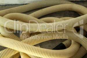 Yellow plastic corrugated tubes for water supply, rolled up