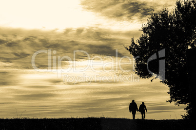 silhouette of a couple walking in the evening