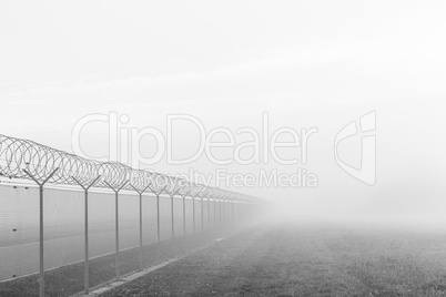 long fence hiding in the fog