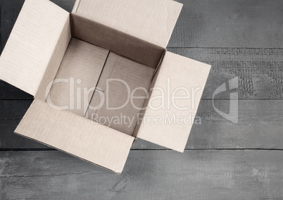 Cardboard box for postal items on a wooden background.