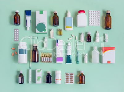 Various forms of medicines on a light green background