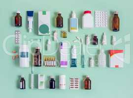 Various forms of medicines on a light green background