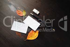 Business cards, pencil, eraser, leaves