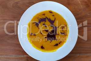 Pumpkin cream soup in a white plate
