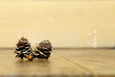 Yellow blurred background with spruce cones in the foreground