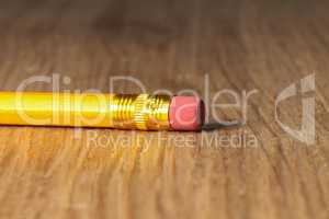 Close up of a used single yellow pencil eraser