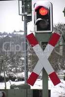 Red traffic lights at the railway crossing