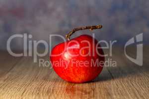 Beautiful red apple lies on the table