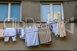 Laundry dries under the windows of a high-rise building