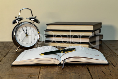 Pen lying on calendar or organizer on desk in office