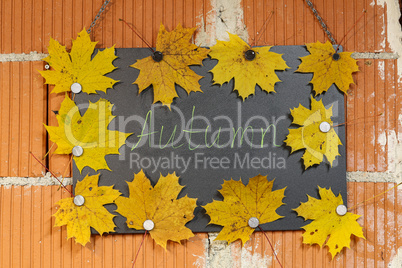 AUTUMN - Inscription on a black board decorated with maple leaves