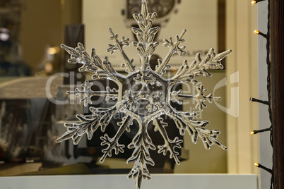 Crystal snowflake hangs in a shop window