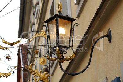 Old street lamps illuminate the way for passersby
