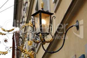 Old street lamps illuminate the way for passersby