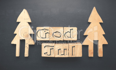 Wooden tree shapes and blocks with God Jul
