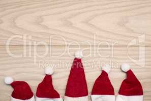 Five hat of Santa on wood