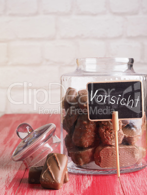 German word Attention on a jar with chocolate bars