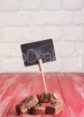Pile of chocolate bars with a chalkboard