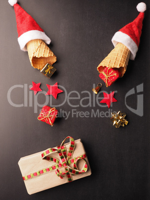 Ice cream cones with hat of Santa and gift boxes