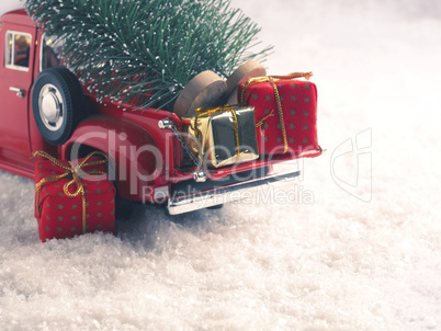 Winter scene with red Christmas truck and gift boxes