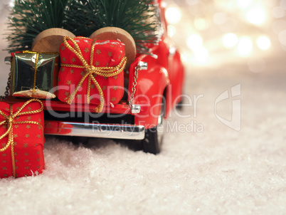 Winter scene with red Christmas truck and gift boxes